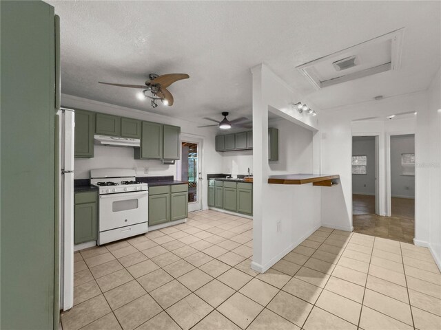 kitchen featuring green cabinets, light tile patterned floors, a textured ceiling, white appliances, and ceiling fan