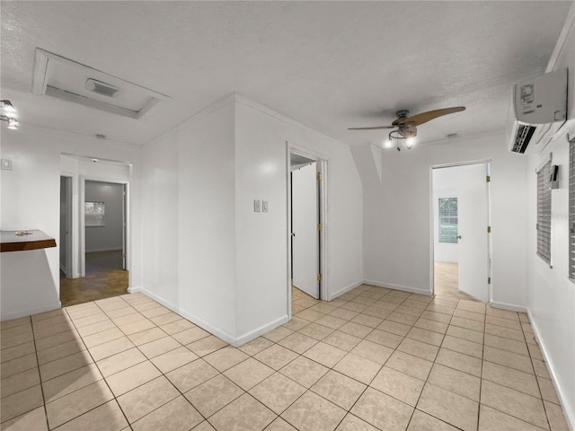 unfurnished room featuring ceiling fan, a textured ceiling, light tile patterned floors, and ornamental molding