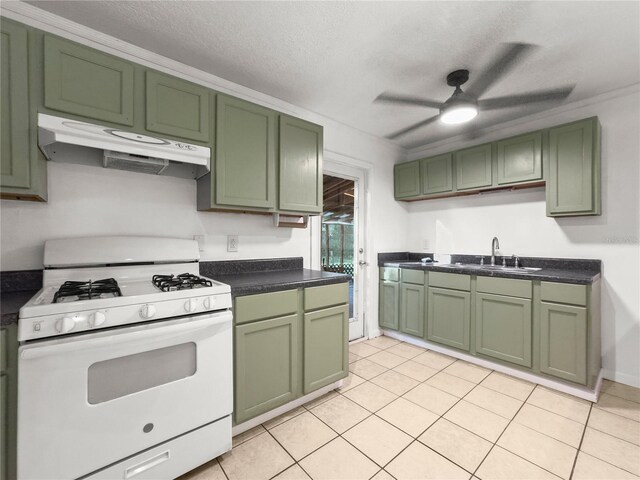 kitchen featuring green cabinetry, sink, white range with gas cooktop, and light tile patterned floors