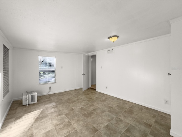 empty room featuring ornamental molding