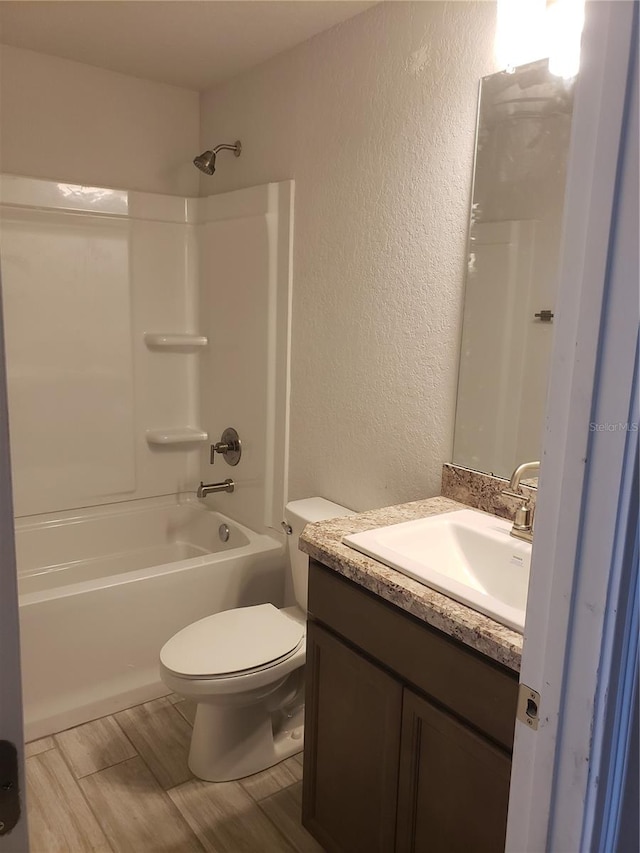 full bathroom featuring vanity, wood-type flooring, toilet, and tub / shower combination