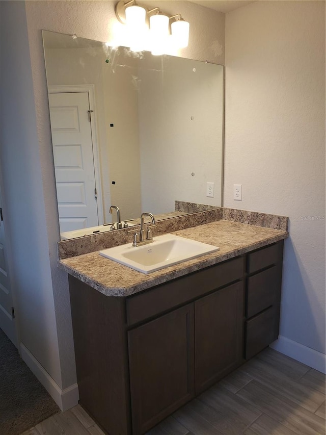 bathroom featuring vanity and wood-type flooring