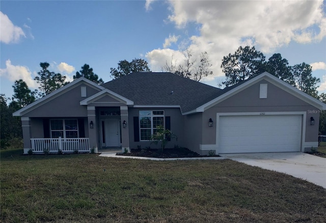 view of front of house with a front yard, a garage, and a porch