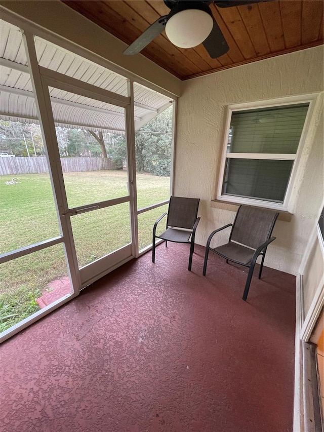 sunroom / solarium with wood ceiling and ceiling fan