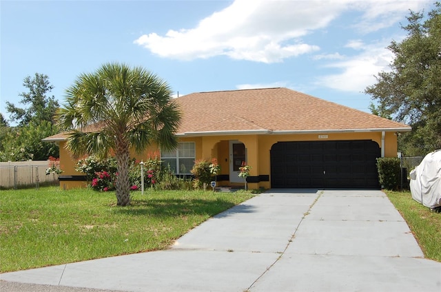 view of front facade with a garage and a front lawn