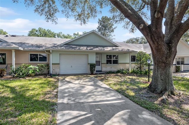 ranch-style house with a garage and a front lawn