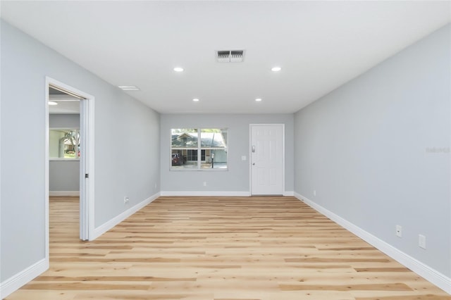 spare room featuring light wood-type flooring