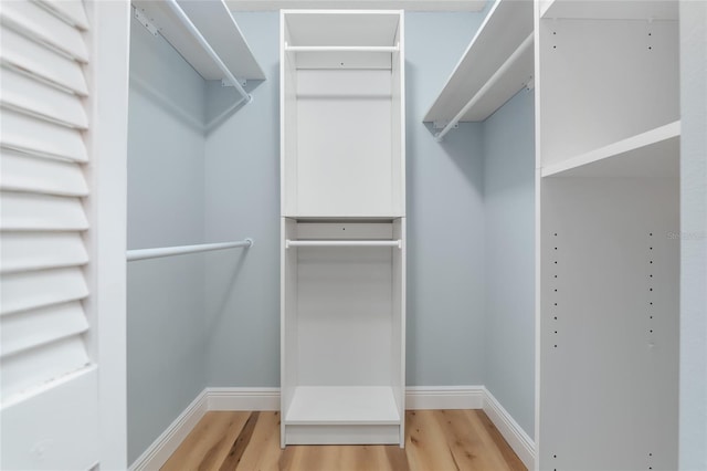 spacious closet featuring hardwood / wood-style floors