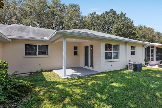 back of property featuring a yard, a patio area, and central air condition unit