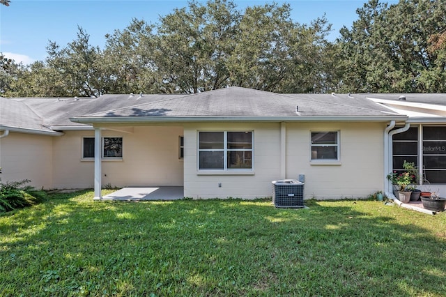 back of house featuring a yard, central air condition unit, and a patio