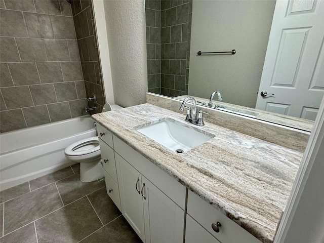 full bathroom featuring tile patterned floors, toilet, vanity, and tiled shower / bath combo