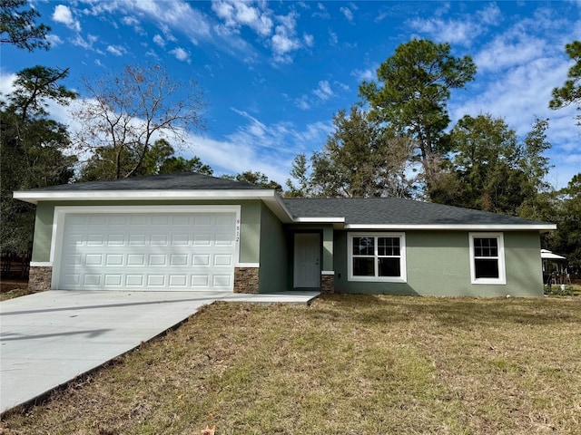 ranch-style house featuring a garage and a front lawn