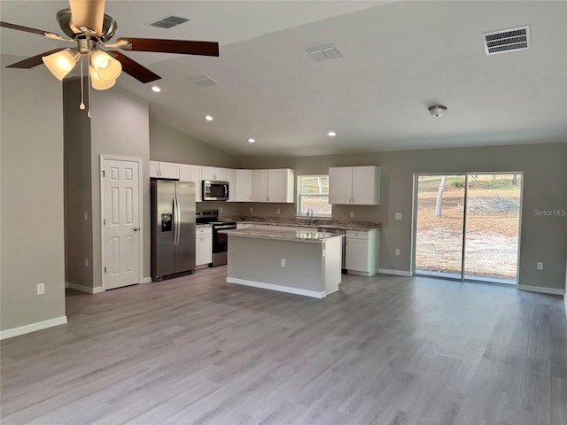 kitchen with ceiling fan, a center island, light hardwood / wood-style flooring, stainless steel appliances, and white cabinets