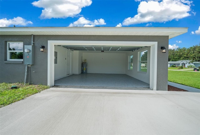 garage featuring electric panel and driveway