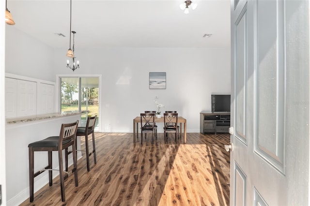 interior space featuring a chandelier, pendant lighting, and dark hardwood / wood-style flooring