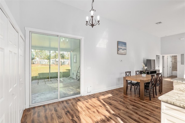 dining area featuring a chandelier and dark hardwood / wood-style floors