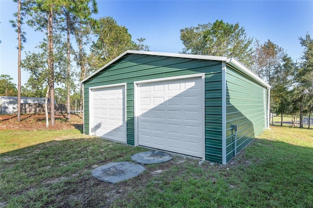 garage featuring a lawn