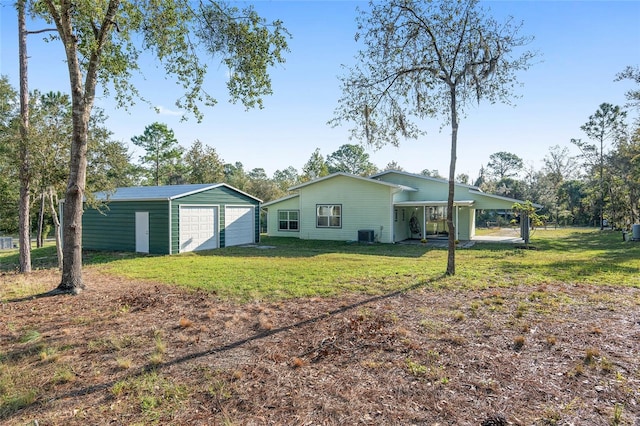 exterior space featuring a garage, central AC unit, an outdoor structure, and a carport