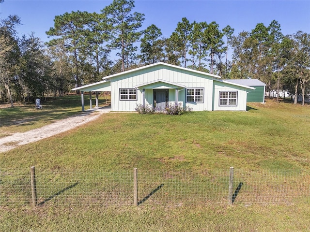 view of front facade featuring a front lawn and a carport