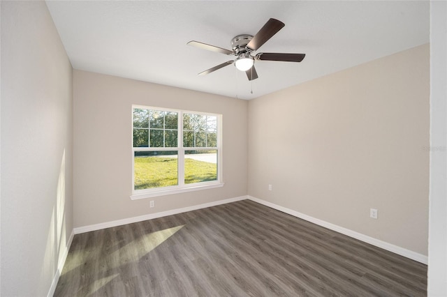 empty room with dark hardwood / wood-style floors and ceiling fan