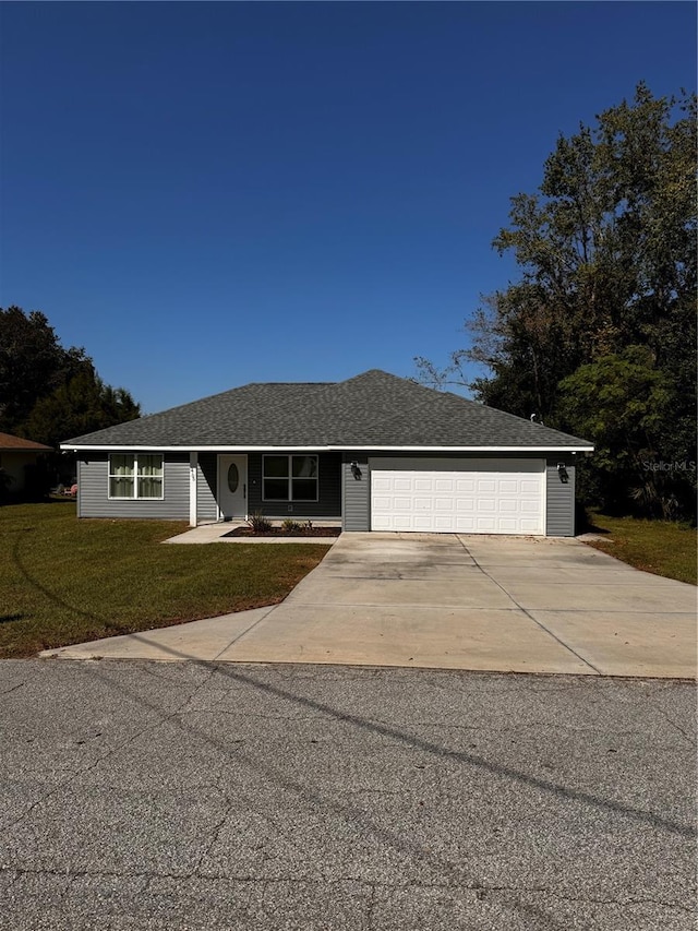 view of front of property featuring a front lawn and a garage