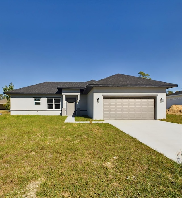 view of front of house with a front yard and a garage