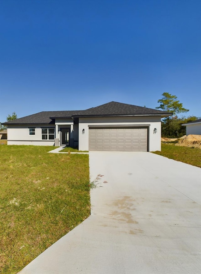 view of front of property with a garage and a front yard