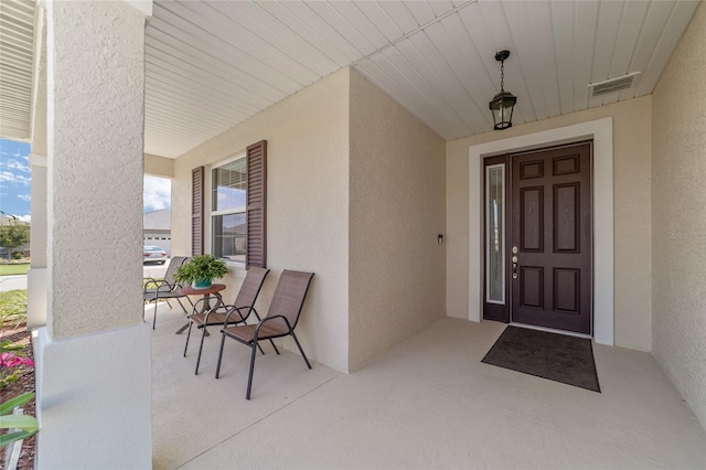 view of exterior entry with covered porch