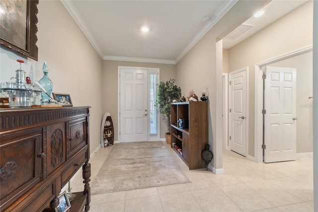 foyer featuring crown molding and light tile patterned floors