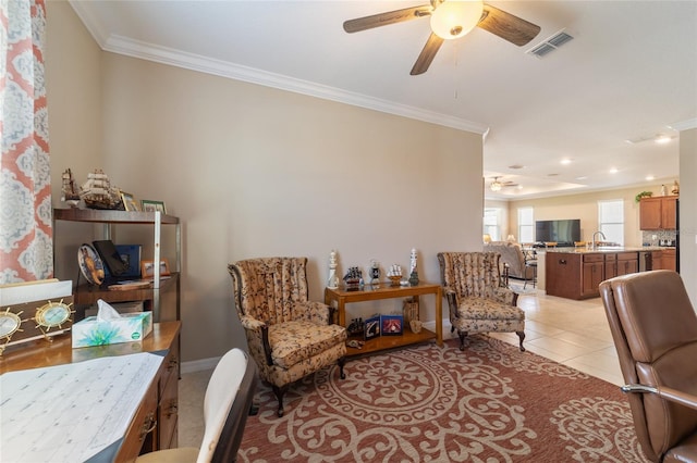 office area with sink, crown molding, ceiling fan, and light tile patterned floors