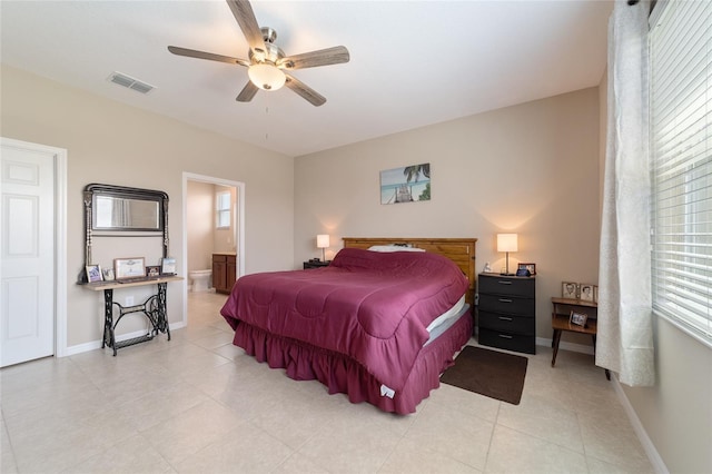 bedroom with light tile patterned floors, connected bathroom, and ceiling fan