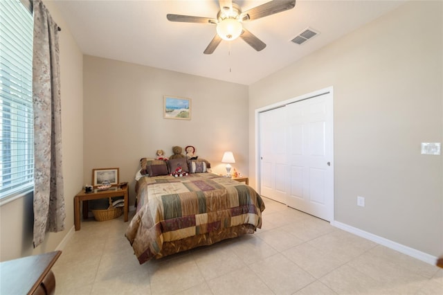 tiled bedroom featuring a closet and ceiling fan