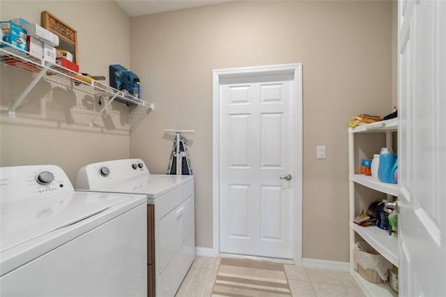 laundry area featuring washing machine and dryer and light tile patterned floors