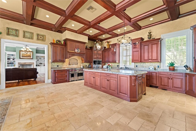 kitchen featuring a center island, coffered ceiling, range with two ovens, beamed ceiling, and decorative light fixtures