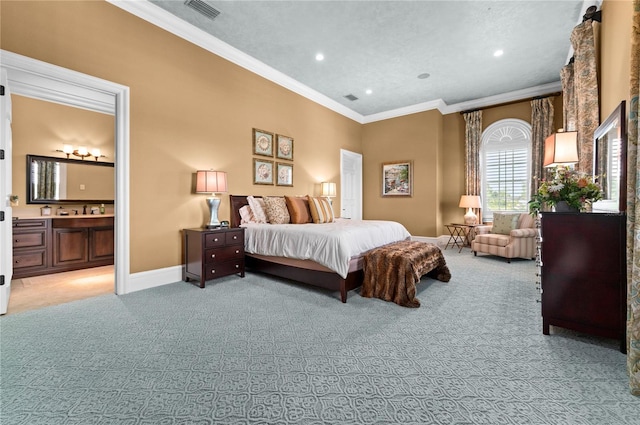 carpeted bedroom with ensuite bath and crown molding