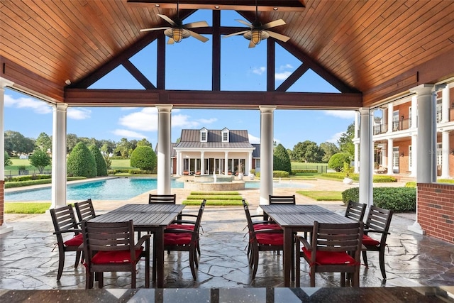 view of patio / terrace with outdoor dining area, an exterior structure, ceiling fan, an outdoor pool, and an outdoor structure