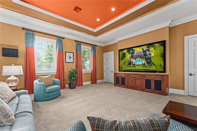 home theater room with carpet, a raised ceiling, visible vents, and crown molding