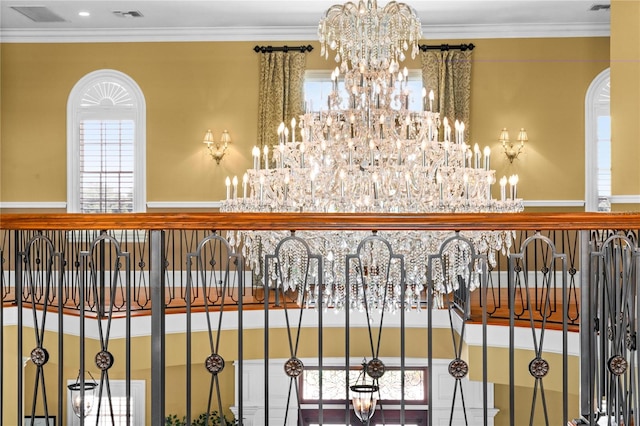 details with visible vents, a chandelier, and ornamental molding