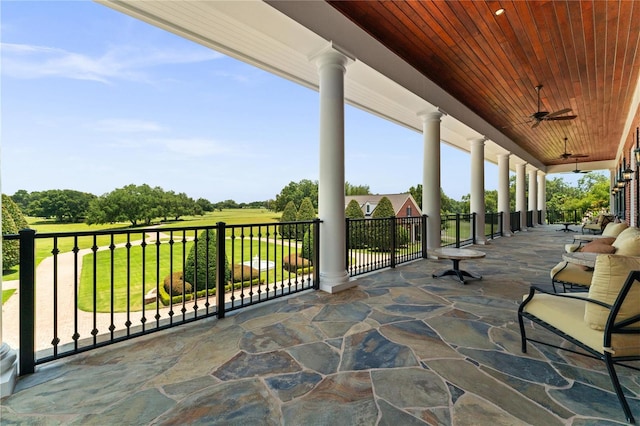 view of patio / terrace with a balcony and a ceiling fan