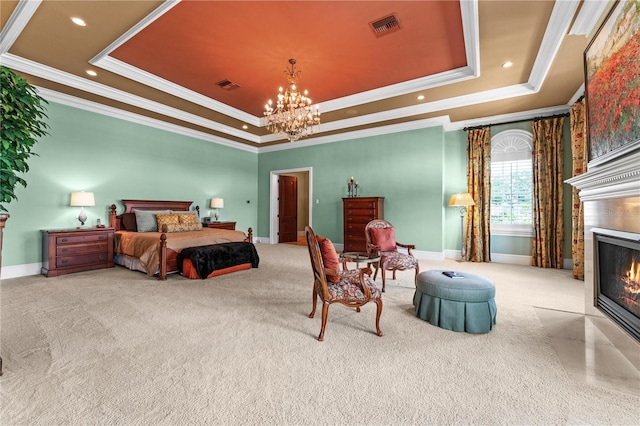 bedroom with an inviting chandelier, a fireplace with flush hearth, visible vents, and a raised ceiling