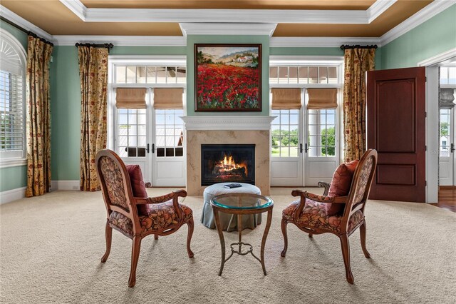 living area with carpet floors, french doors, a fireplace, and crown molding