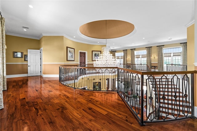 hallway with a chandelier, recessed lighting, wood finished floors, baseboards, and crown molding