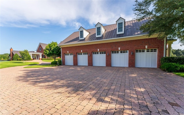 garage with decorative driveway