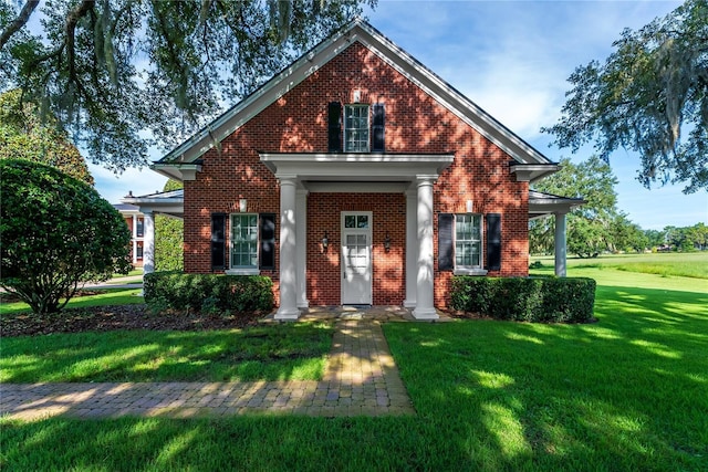 view of front of property with brick siding and a front lawn