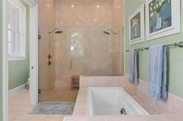 bathroom featuring toilet, tile patterned flooring, a shower stall, and a bath