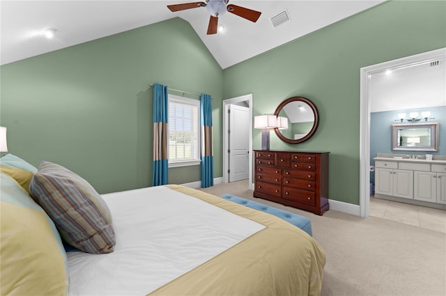 bedroom featuring lofted ceiling, visible vents, light carpet, connected bathroom, and baseboards