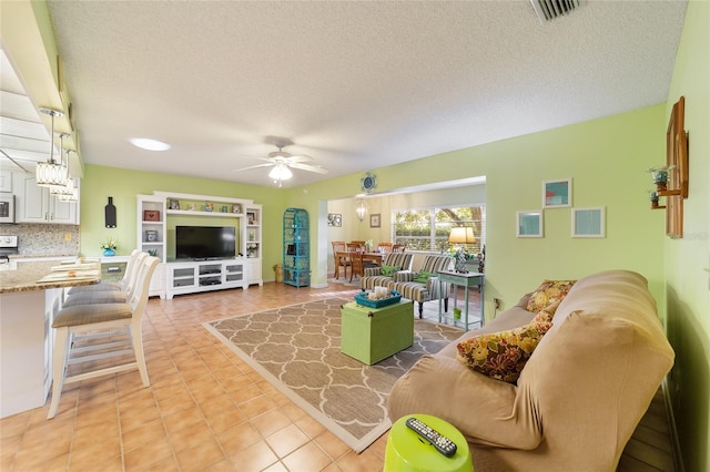 living room with tile patterned flooring, a textured ceiling, and ceiling fan