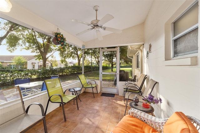 sunroom / solarium featuring a wealth of natural light and ceiling fan