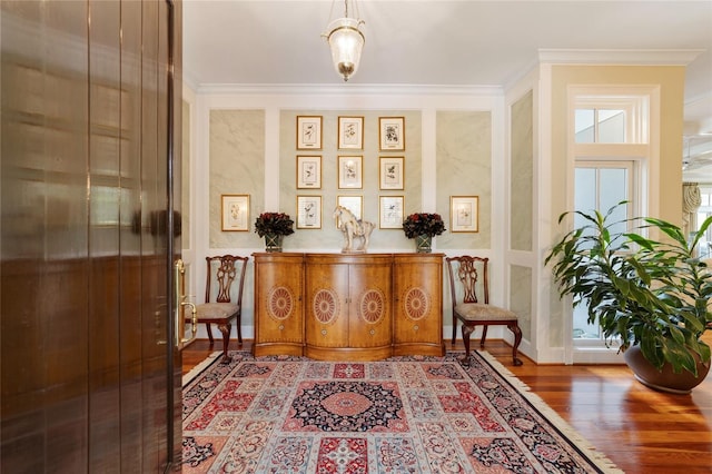 living area with crown molding and hardwood / wood-style floors