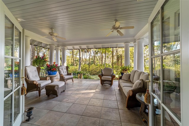 sunroom with decorative columns, wooden ceiling, and ceiling fan